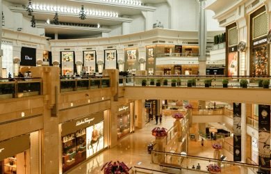 pexels-photo-4027948-4027948 Contemporary design of big mall interior with ribbed column and decorative elements on ceiling with glowing corridors illuminated by artificial lights and signboards with inscriptions